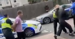 Horrific moment thug brutally punches cop in face in broad daylight