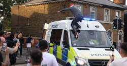 Shocking moment protesters attack police vans outside migrant hotel