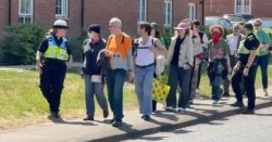 Fury as police officers escort pro-migrant protesters to asylum hotel