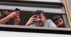 Migrant hotel residents spotted laughing and filming as protests erupt outside