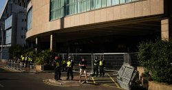 Woman charged with assault after migrant from Canary Wharf hotel &#039;walked into her flat&#039;
