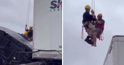 Dramatic moment firefighter rescues trapped driver from truck dangling over bridge